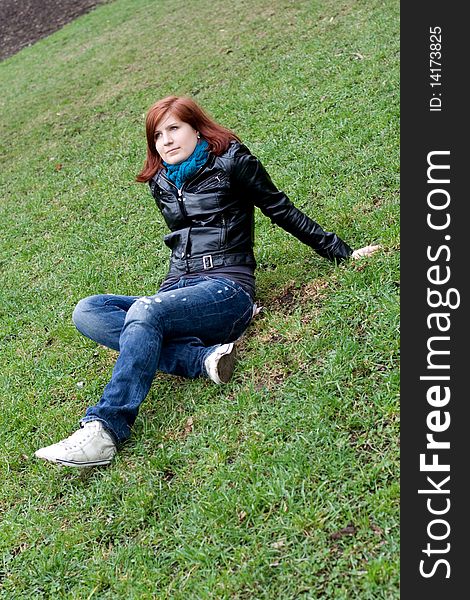 Girl sitting on grass in spring