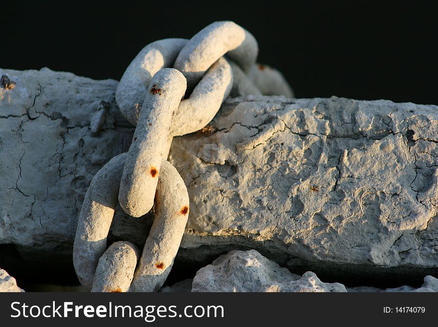 Old muddy boat chain on a dock. Old muddy boat chain on a dock