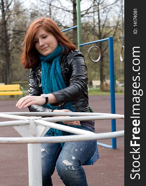 Sportive girl riding carousel