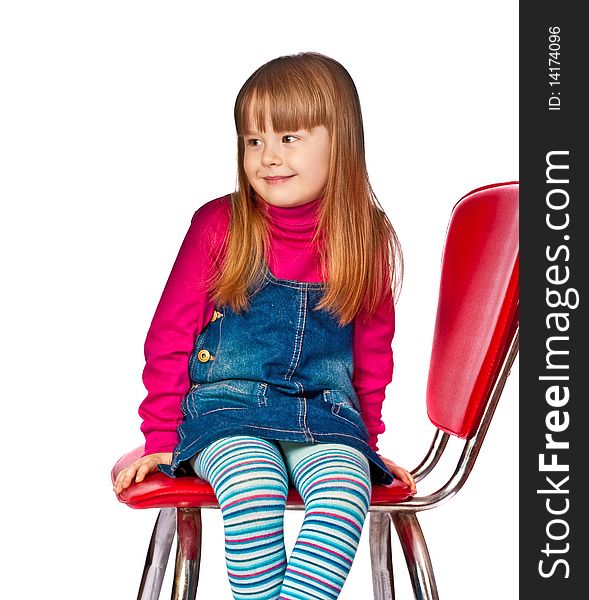 Portrait Of Beautiful Little Girl Sitting On Chair