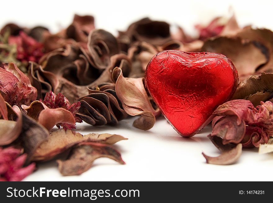 An image of a chocolate with heart shape whit plants decorations. An image of a chocolate with heart shape whit plants decorations