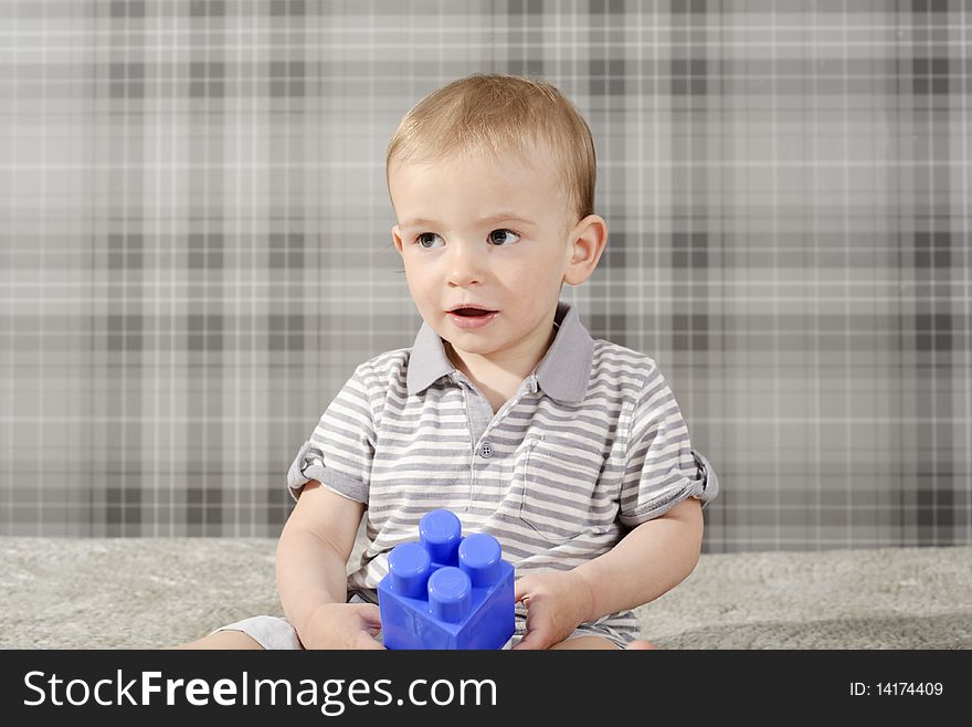 Little, cute boy playing with blue bricks. Little, cute boy playing with blue bricks