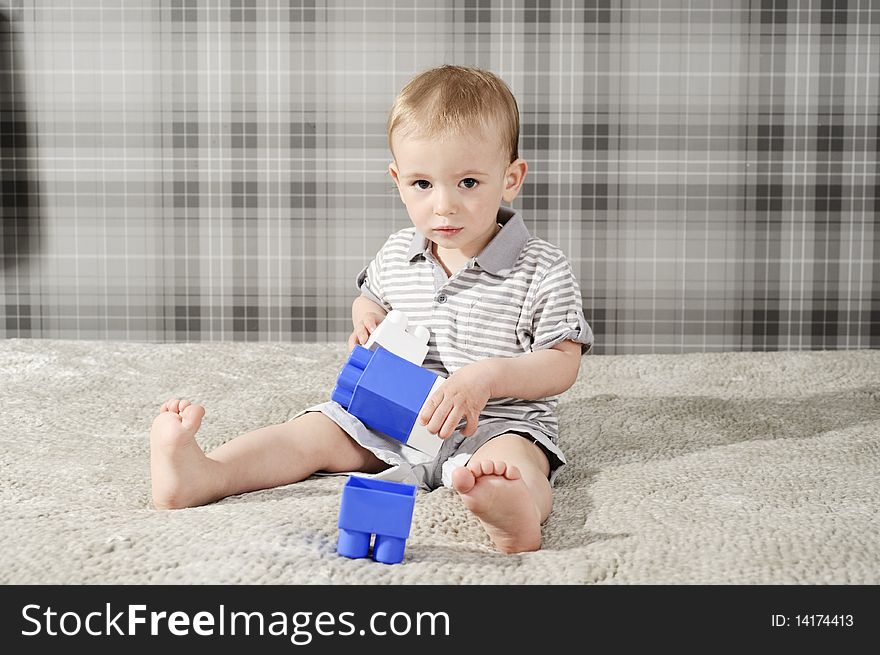 Little, cute boy playing with blue bricks. Little, cute boy playing with blue bricks