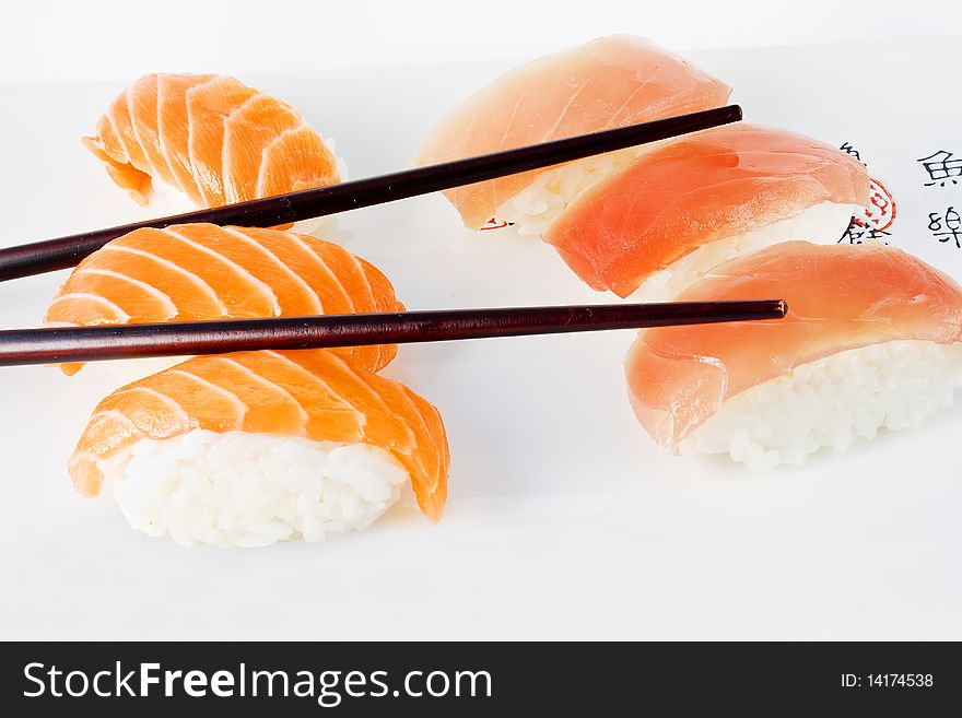 Salmon and tuna sushi with chopsticks in a dish