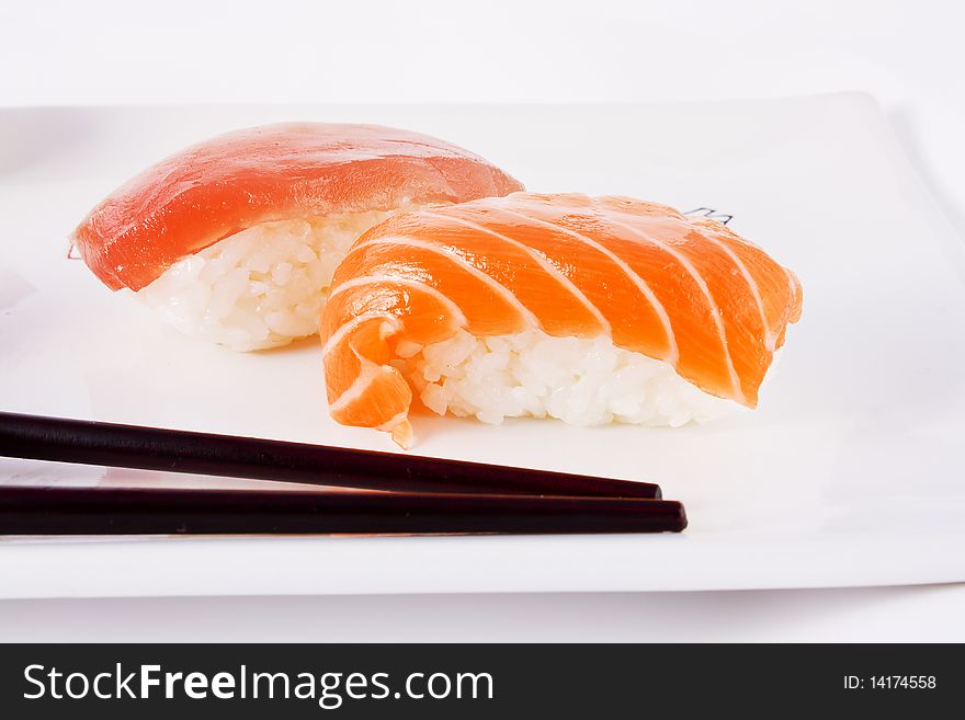 Salmon and tuna sushi with chopsticks in a dish