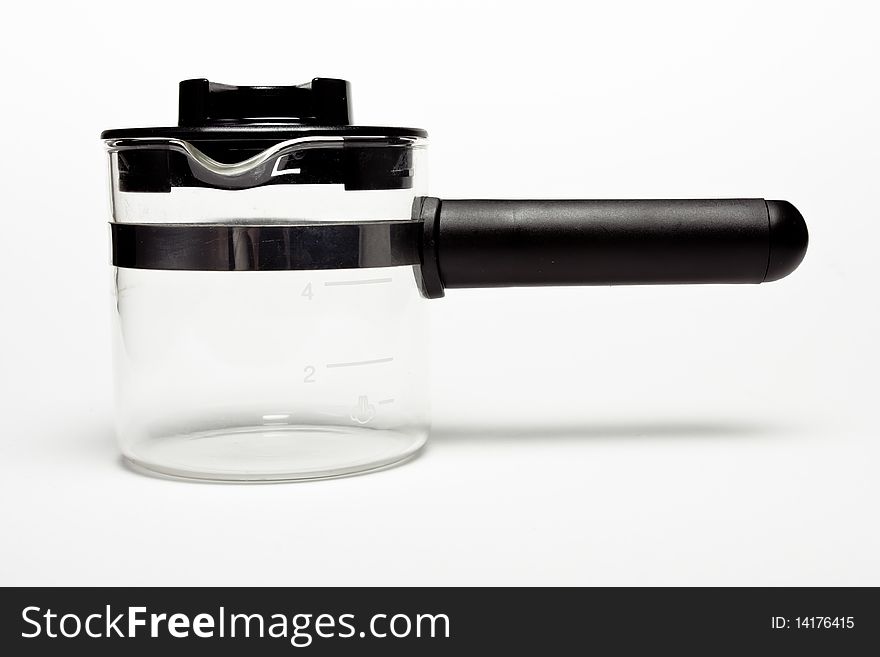 Home espresso / cappuccino milk frothing jug isolated against white background.