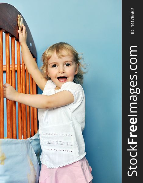 Cheerful little girl from her crib