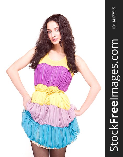 Beautiful young model in colorful dress on white background. Beautiful young model in colorful dress on white background