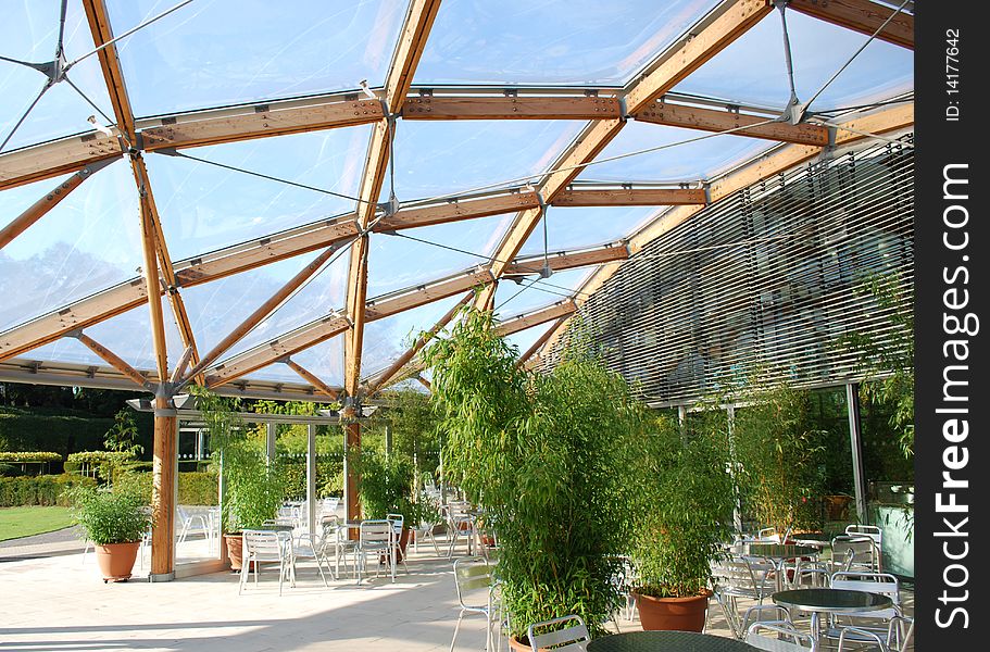 Modern canopy/roof made of wood and plastic above a picnic area with bamboo plants. Modern canopy/roof made of wood and plastic above a picnic area with bamboo plants