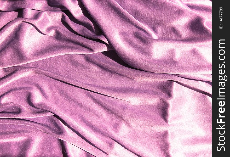 Pink smooth and brilliant fabric with folds. Pink smooth and brilliant fabric with folds.