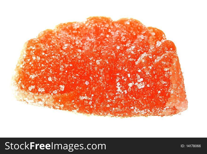 The sweet from fruit candy of orange colour is strewed by sugar.