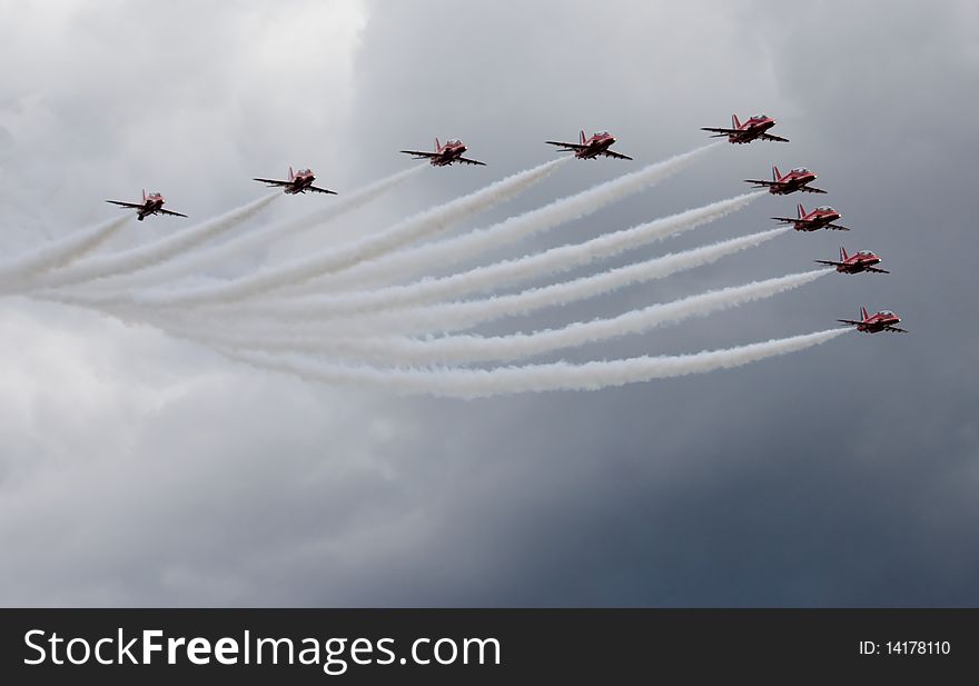 Nine red airplanes flying in formation. Nine red airplanes flying in formation