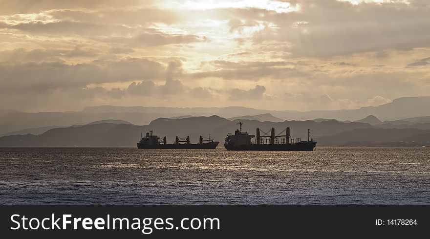 Two haulage cargo boats and sunset