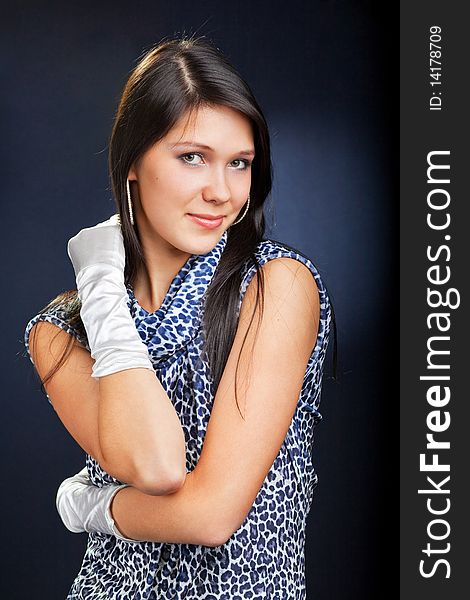 Young beautiful woman in dress and gloves