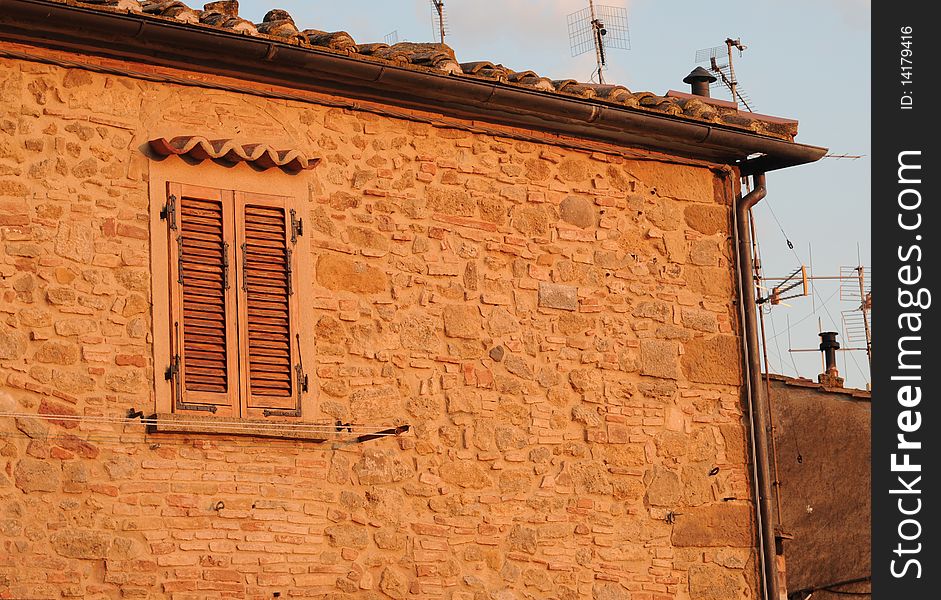 Italian house in Tuscany with antennas, in the evening sun. Italian house in Tuscany with antennas, in the evening sun
