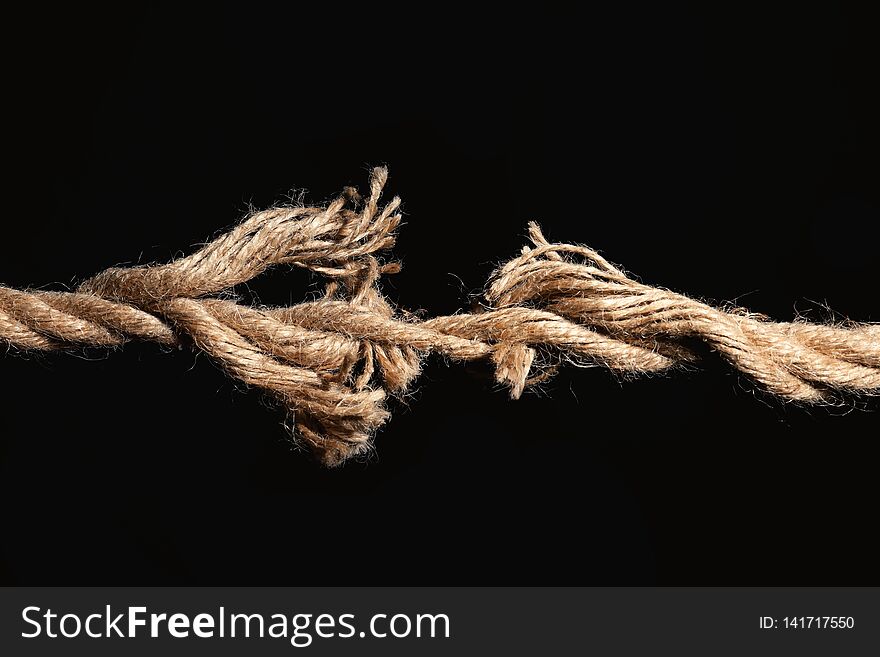 Rupture of cotton rope on black background