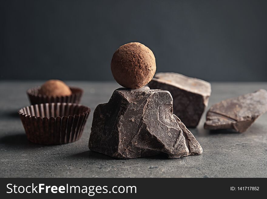 Tasty raw truffle and chocolate lump on grey table