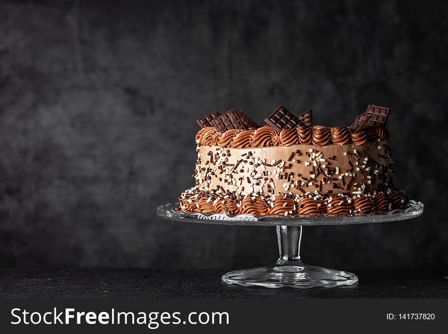 Decorated chocolate cake on dark background