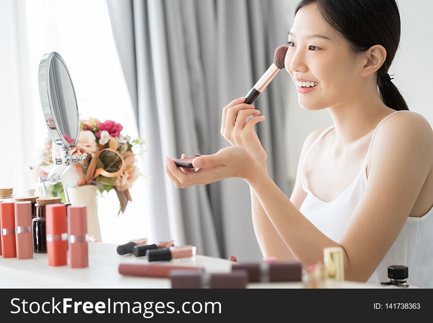 Young Asian female makeup beauty by Makeup Brush.
