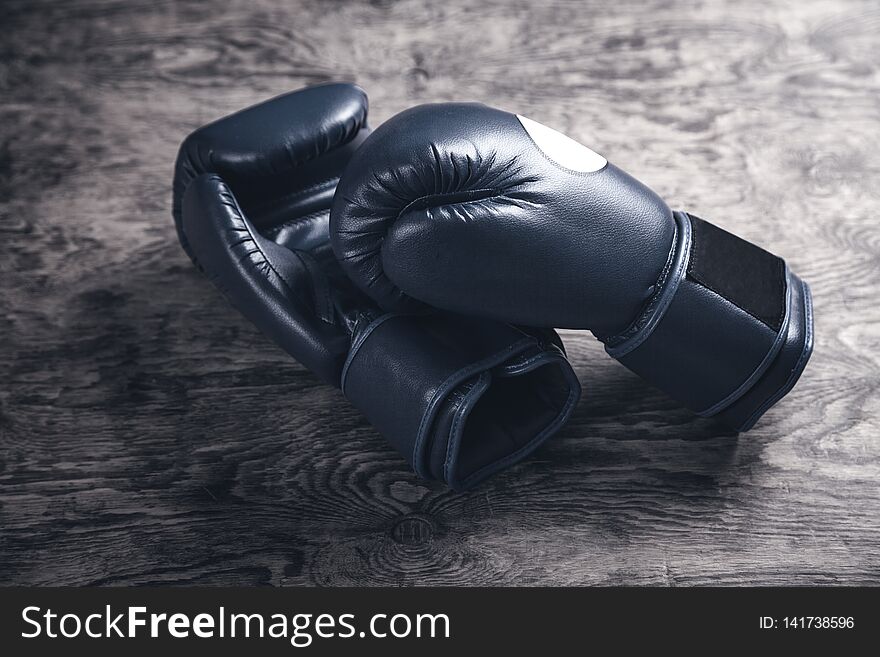 Boxing gloves on old wooden table