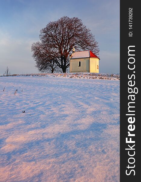 Winter with snow in the countryside with chapel, Slovakia
