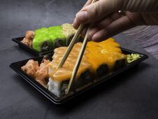 Japanese Sushi On A Dark Background. Sushi Rolls, Pickled Ginger, Wasabi. Sushi Set On A Table Stock Photography Japanese Sushi On A Dark Background. Sushi Rolls, Pickled Ginger, Wasabi. Sushi Set On A Table Stock Photography