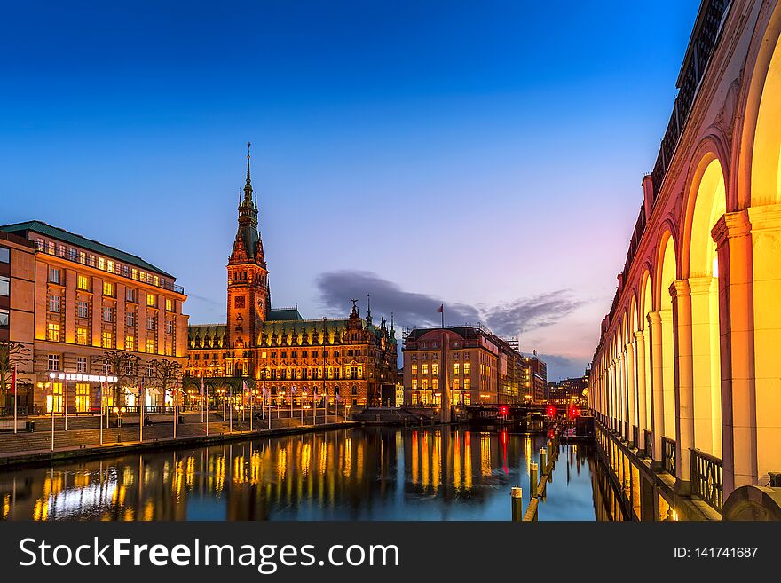 View of Hamburg townhall Rathaus and small Alster lake during twilight sunset