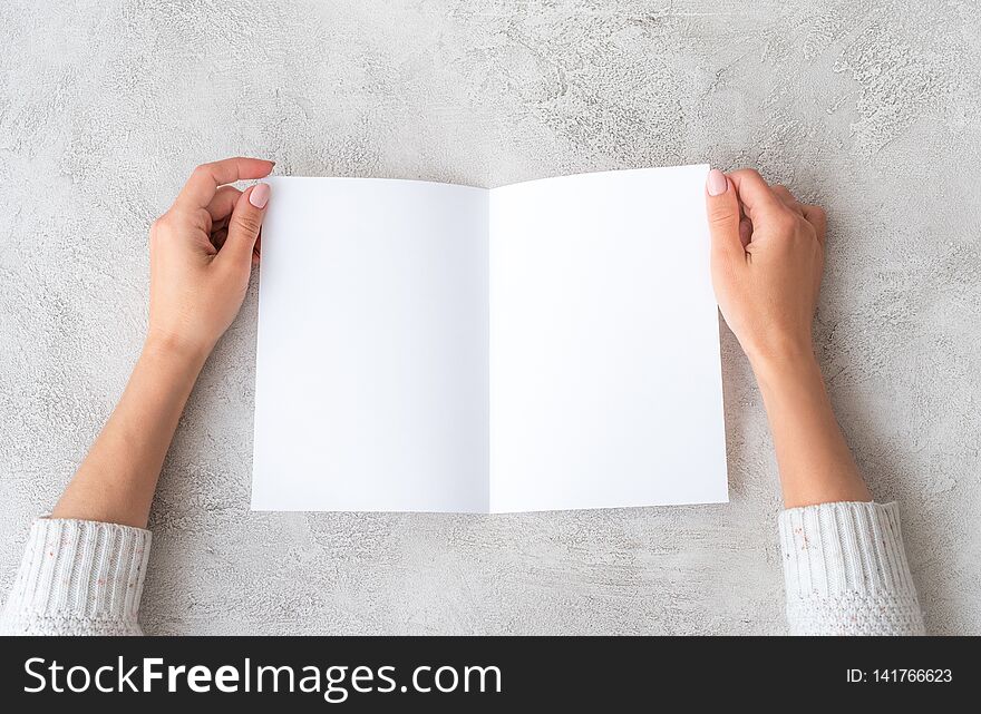 Girl` hands holding sheet of paper