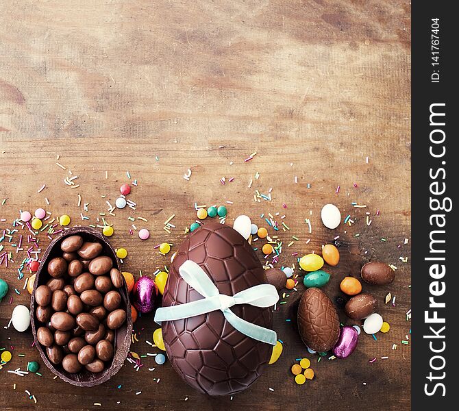 Beautiful creative photo with Chocolate Easter eggs on wooden background. Happy Easter..