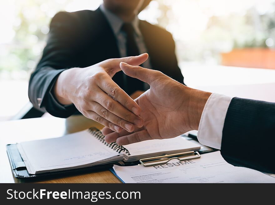 Business people accept or confirm project on the proposal and join shaking hands at office