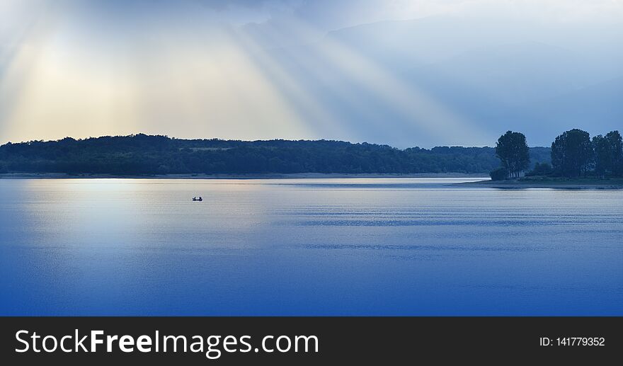 Beautiful Blue Nature Background.Fantasy Design.Artistic Wallpaper.Art Photography.Sky,clouds,water.Lake,trees.Mountain,boat.Light