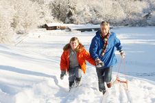 Father And Son Pulling Sledge Up Snowy Hill Stock Photos Father And Son Pulling Sledge Up Snowy Hill Stock Photos