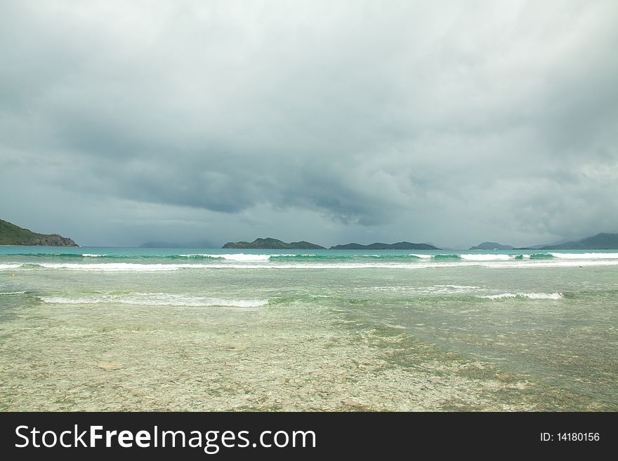 Stormy beach shore of St Thomas with an incoming storm on the horizon. Stormy beach shore of St Thomas with an incoming storm on the horizon.