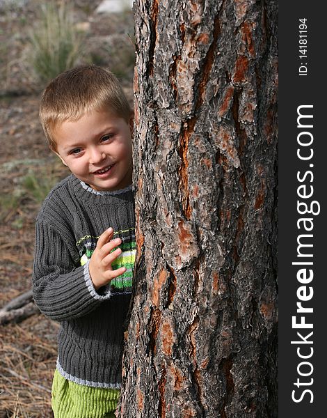 Beautiful blond boy playing outdoors on a spring day