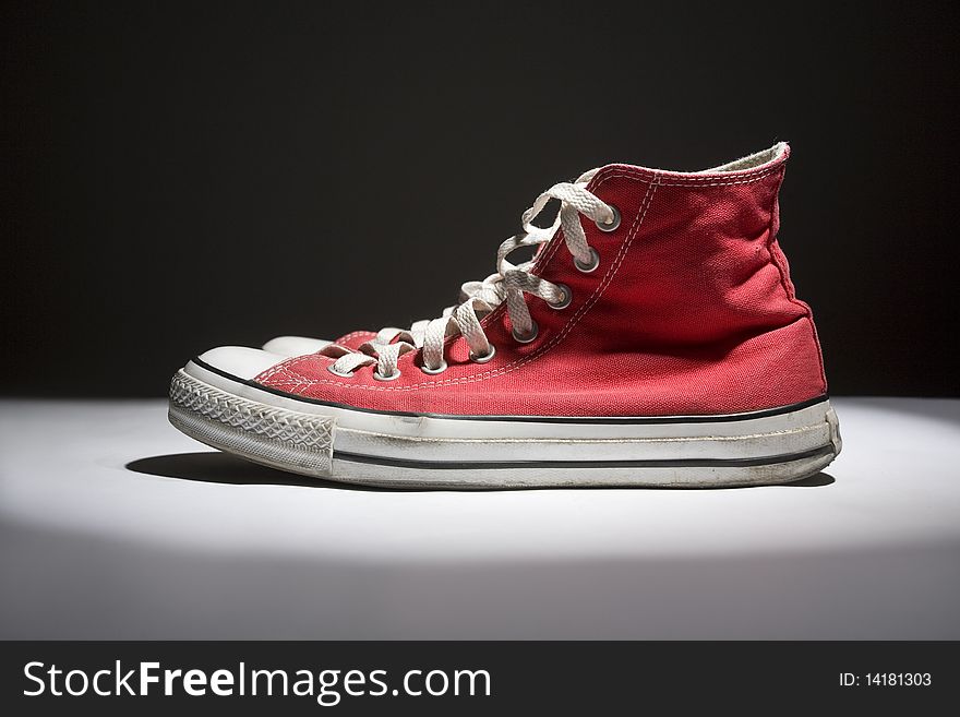Brand new red sneakers on white background