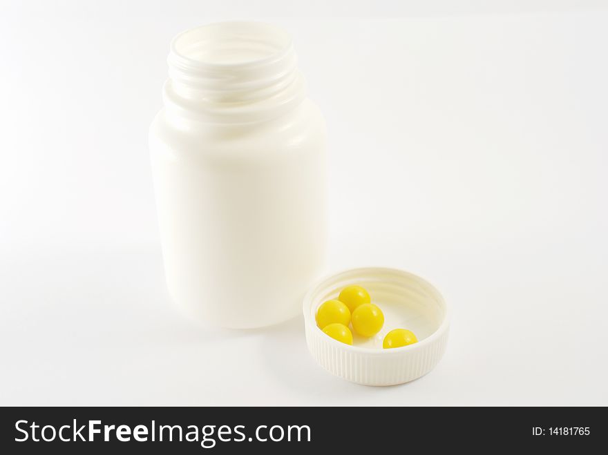 Vitamin C in white cover from vial with vitamins.