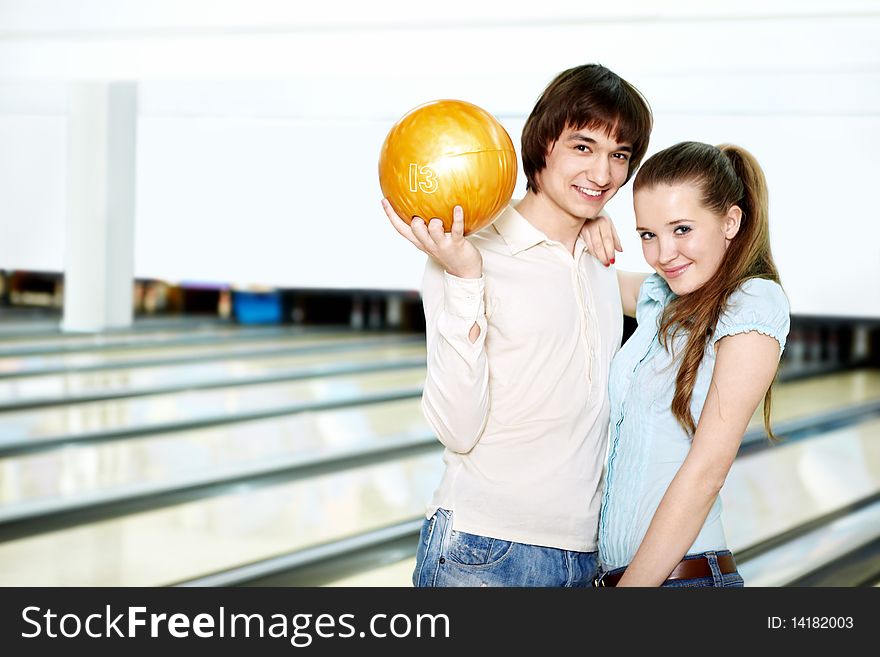 Young couple with a sphere for bowling. Young couple with a sphere for bowling