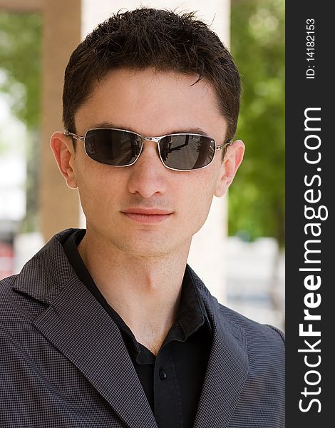 Young businessman in sunglasses and jacket. Young businessman in sunglasses and jacket