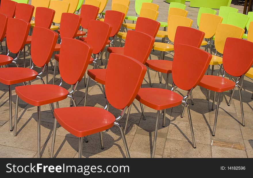 Colored chairs arranged in rows. Colored chairs arranged in rows