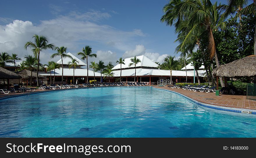 Pool with blue water near a hotel on a tropical resort. Pool with blue water near a hotel on a tropical resort