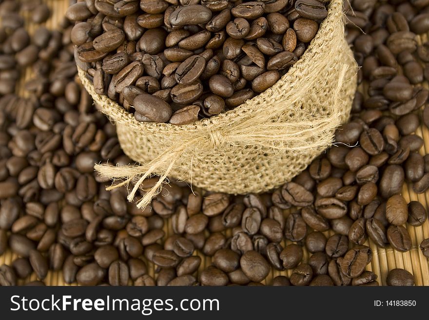 Coffee beans are in the bag and scattered on the table