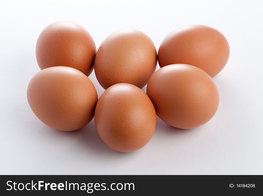 Still-life half-dozen eggs on a white background and soft light. Still-life half-dozen eggs on a white background and soft light