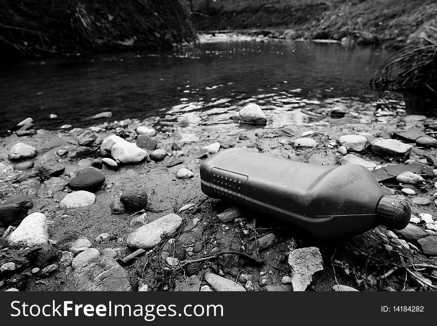 Plastic container on the river. Water pollution.