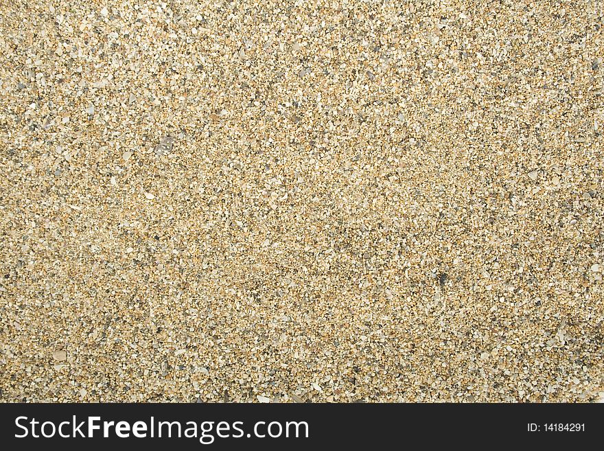 Sea sand with remnants of shells and small pebbles. Background