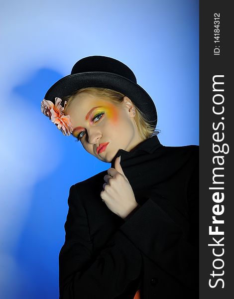Elegant fashion woman with creative eye make-up. blue background