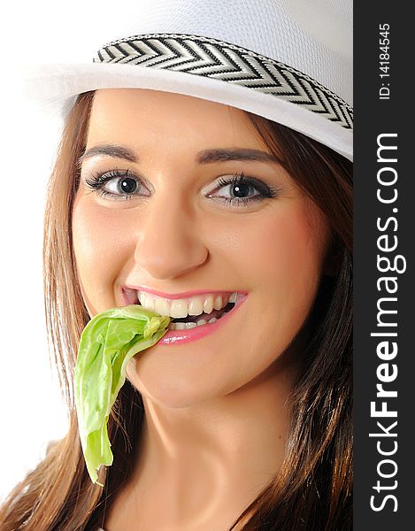 Young pretty woman eating green salad leaf