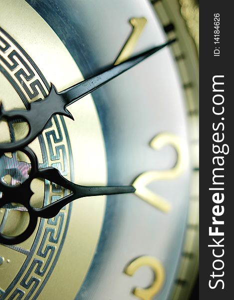 Closeup view of the clock hands of an antique clock