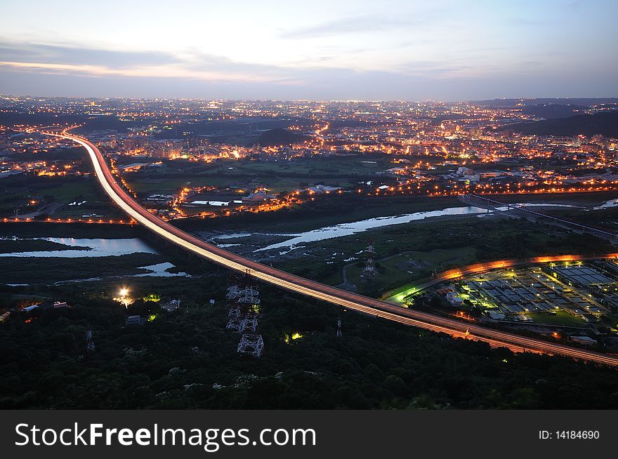 A sunset with a highway in the city