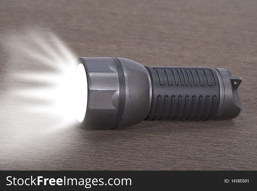 This image shows a flashlight, perched on a table