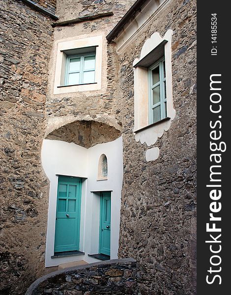 Front of an old stone house in an ancient restored village in northern italian country. Front of an old stone house in an ancient restored village in northern italian country